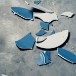 A broken blue and white plate on the ground used by The Break Room 831