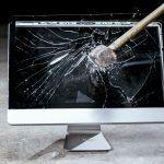 A sledge hammer smashing a computer screen used by The Break Room 831
